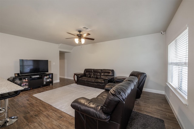 living room with ceiling fan, baseboards, visible vents, and wood tiled floor