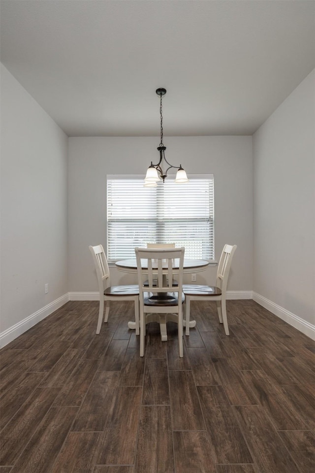 dining room with baseboards, dark wood-type flooring, and a healthy amount of sunlight