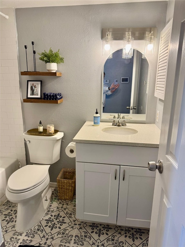 bathroom featuring visible vents, toilet, tile patterned flooring, vanity, and a textured wall