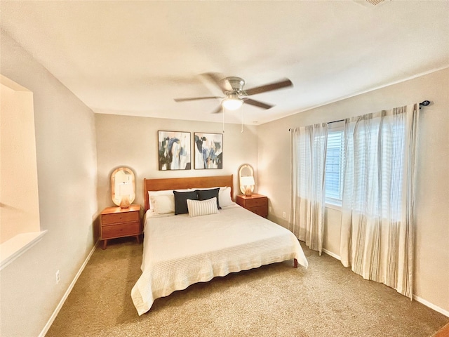 carpeted bedroom featuring baseboards and a ceiling fan