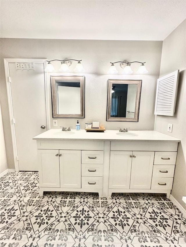 bathroom with double vanity, tile patterned floors, and a sink