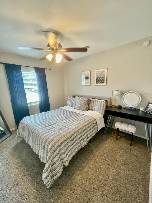 carpeted bedroom with visible vents, baseboards, and ceiling fan