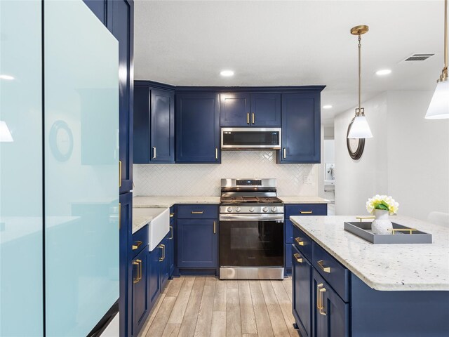 kitchen with blue cabinets, light wood-type flooring, visible vents, tasteful backsplash, and stainless steel appliances