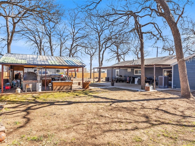 view of yard featuring a patio area, central AC, and fence