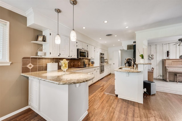 kitchen featuring light wood finished floors, a peninsula, open shelves, stainless steel appliances, and white cabinets