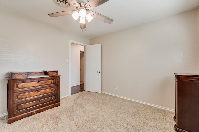 carpeted bedroom featuring visible vents, baseboards, and a ceiling fan