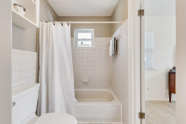 full bathroom with toilet, tile walls, and shower / bathtub combination with curtain