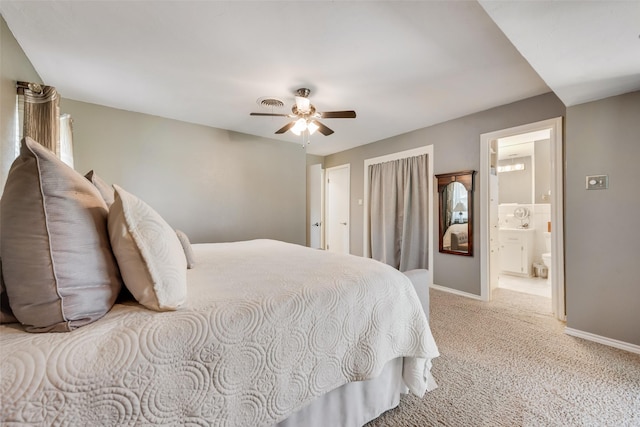 bedroom with visible vents, light carpet, connected bathroom, baseboards, and ceiling fan