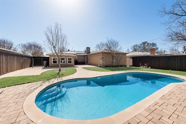 view of pool with a patio area, a fenced in pool, a yard, and a fenced backyard