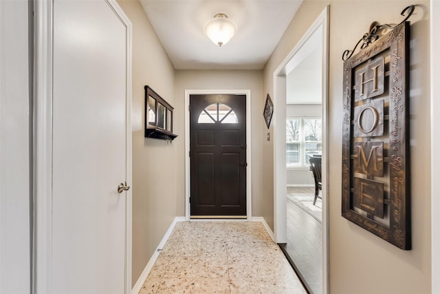 doorway featuring baseboards