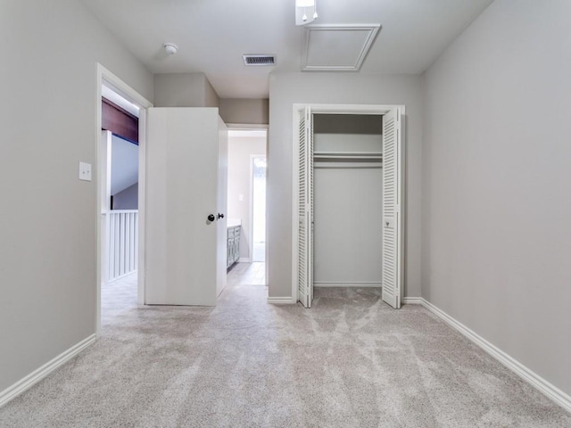 unfurnished bedroom featuring a closet, visible vents, baseboards, and carpet floors