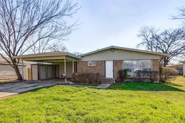 view of front facade featuring brick siding, concrete driveway, and a front yard