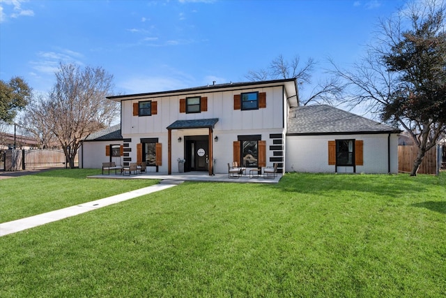 rear view of property featuring a patio, fence, and board and batten siding