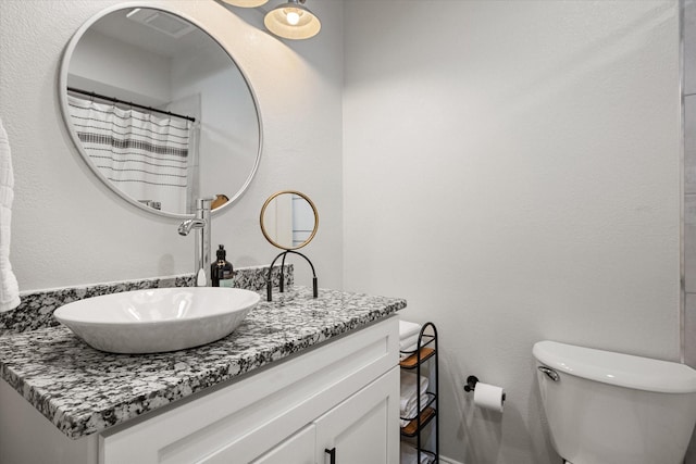 bathroom featuring toilet and vanity