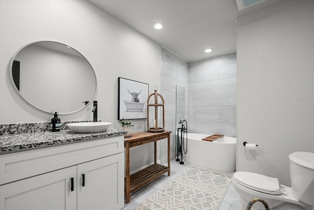 full bathroom with vanity, a freestanding tub, recessed lighting, tile patterned flooring, and toilet