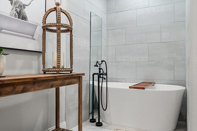 full bathroom with a soaking tub and tile walls