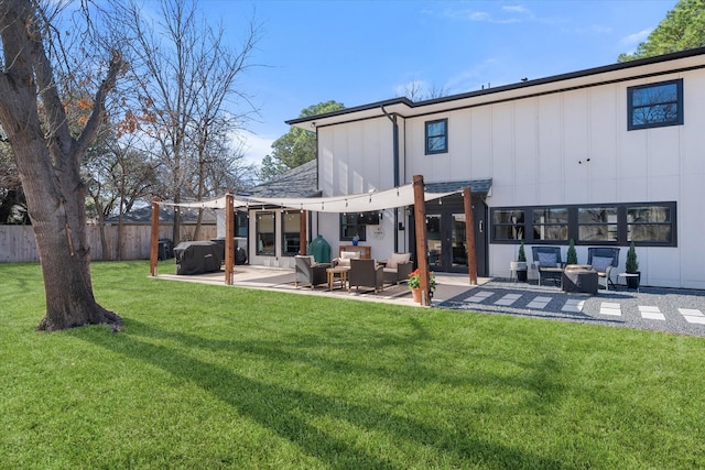 back of house with a lawn, an outdoor hangout area, board and batten siding, and fence