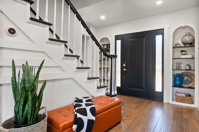 entrance foyer featuring recessed lighting, stairway, and hardwood / wood-style flooring