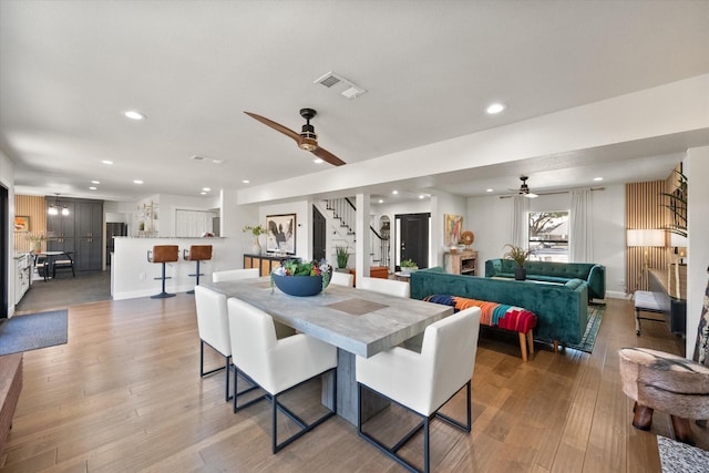 dining room featuring stairway, recessed lighting, visible vents, and light wood-type flooring