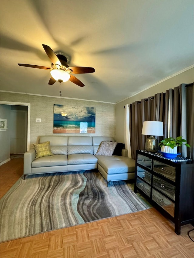 living area featuring crown molding and a ceiling fan