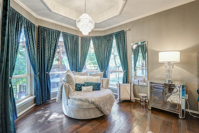 living area with hardwood / wood-style flooring, a tray ceiling, crown molding, a chandelier, and a textured wall