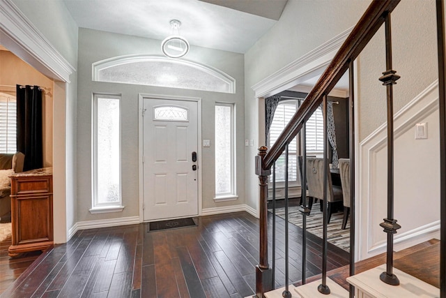 foyer with stairway, baseboards, and dark wood-style floors