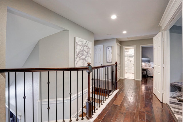 hallway featuring baseboards, attic access, recessed lighting, dark wood-style flooring, and an upstairs landing