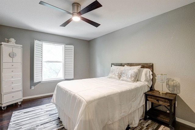 bedroom with baseboards, wood finished floors, and a ceiling fan