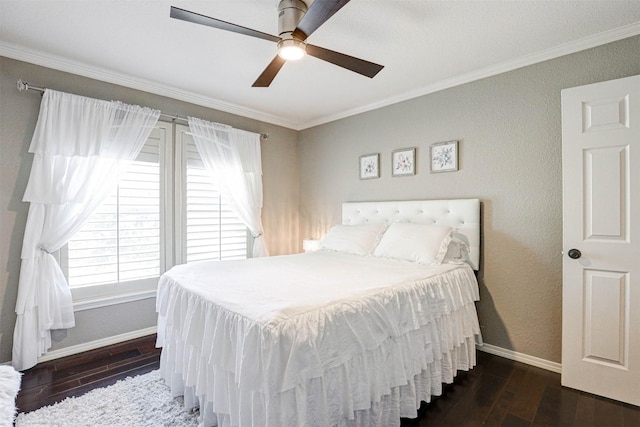 bedroom with crown molding, baseboards, and wood finished floors