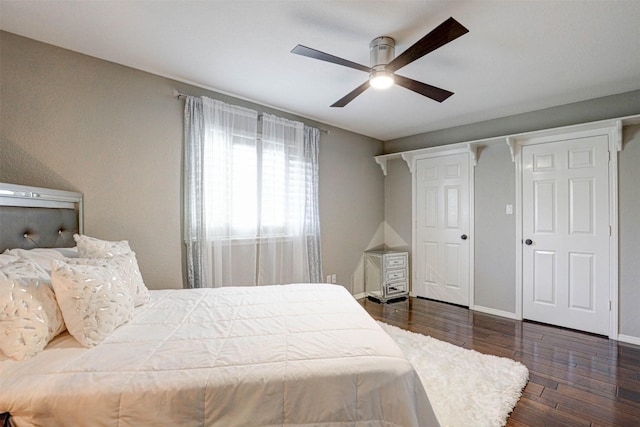 bedroom featuring ceiling fan, baseboards, and wood finished floors