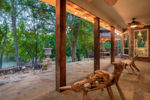 view of patio with outdoor dining area and a ceiling fan