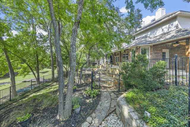 view of yard featuring ceiling fan, a fenced backyard, and a patio area