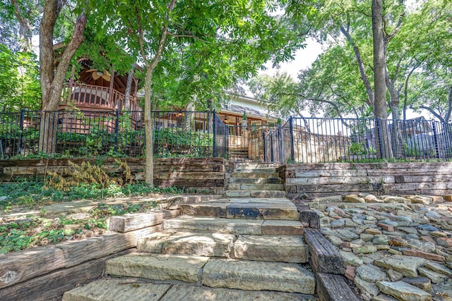 view of yard with stairs and fence