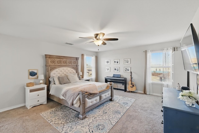 bedroom with light carpet, visible vents, a ceiling fan, and baseboards