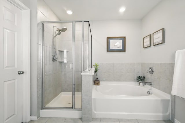 full bathroom with a bath, tile patterned flooring, recessed lighting, and a stall shower