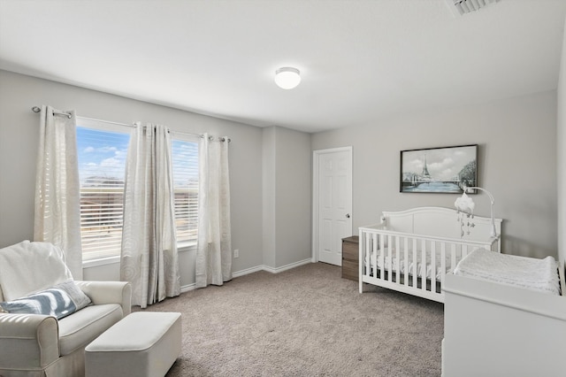 carpeted bedroom featuring visible vents and baseboards