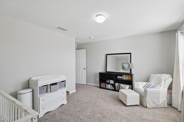 living area with carpet flooring, visible vents, and baseboards