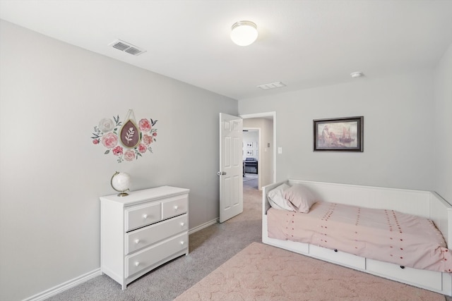 bedroom with baseboards, visible vents, and light carpet