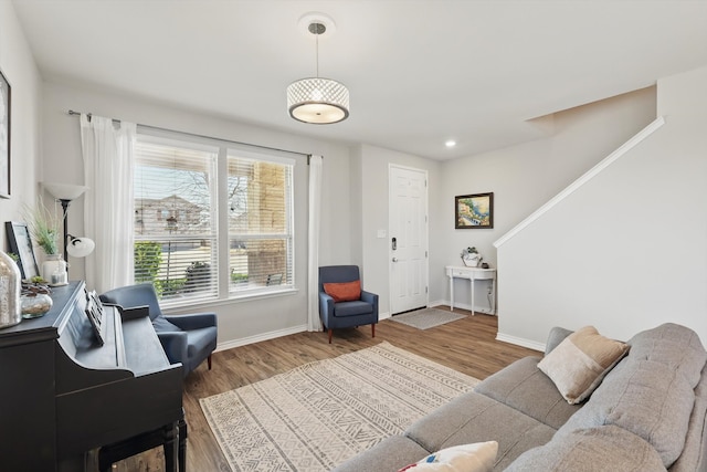 living area featuring stairway, recessed lighting, baseboards, and wood finished floors