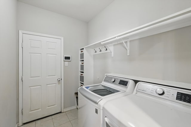 laundry area featuring light tile patterned floors, independent washer and dryer, and laundry area