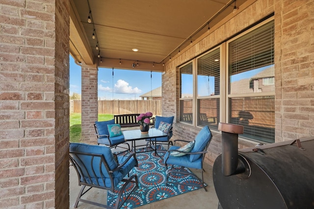 view of patio with an outdoor hangout area and fence