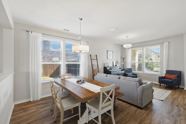 dining area with visible vents, baseboards, and dark wood finished floors