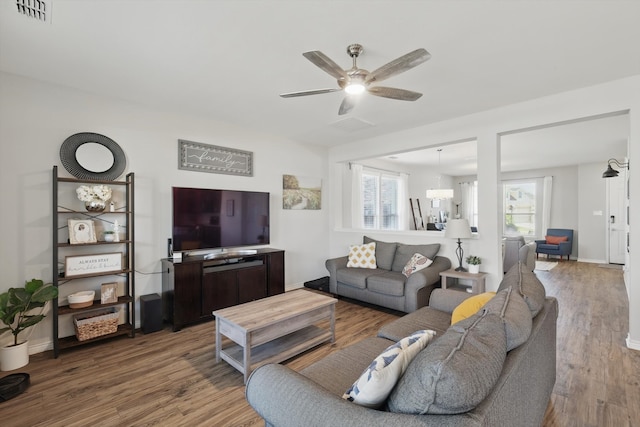 living room with visible vents, a healthy amount of sunlight, and wood finished floors