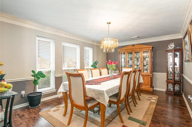 dining space with a chandelier, a healthy amount of sunlight, crown molding, and wood finished floors