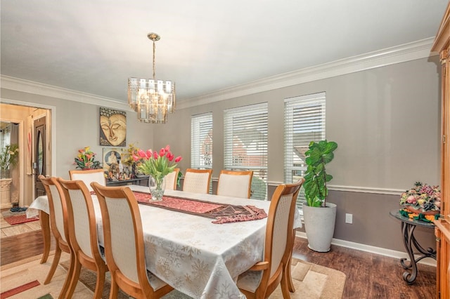 dining area featuring baseboards, a notable chandelier, wood finished floors, and ornamental molding