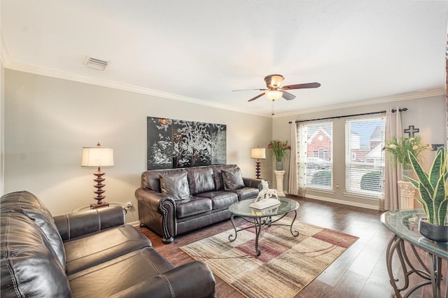 living room with visible vents, a ceiling fan, wood finished floors, and crown molding