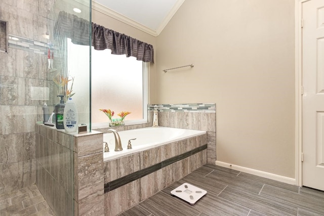 bathroom featuring a garden tub, walk in shower, baseboards, and ornamental molding