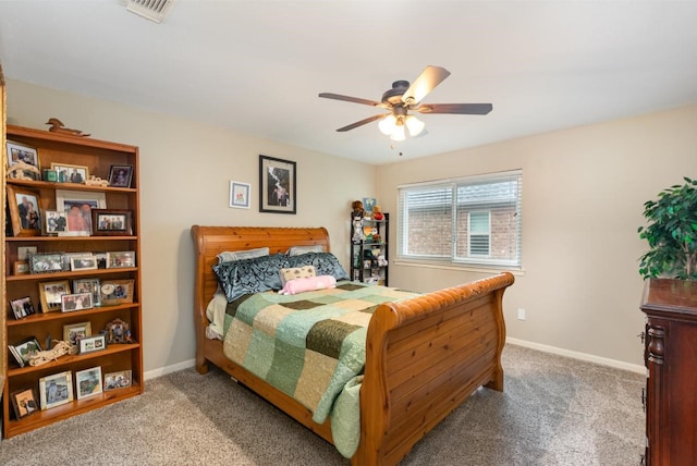 carpeted bedroom with visible vents, baseboards, and a ceiling fan