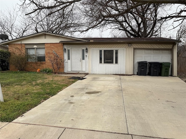 ranch-style house featuring brick siding, driveway, an attached garage, and a front lawn