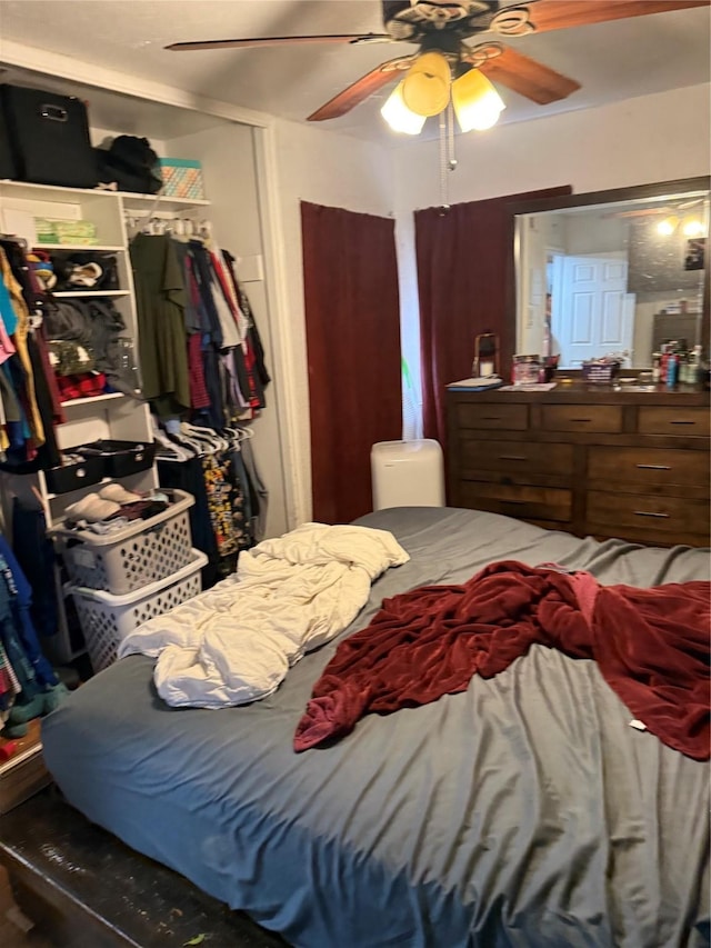 bedroom with a ceiling fan and a closet